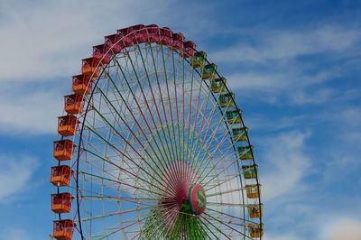 Low angle view of ferris wheel against sky