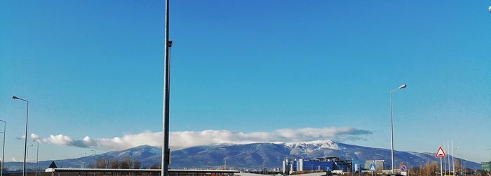 Scenic view of mountains against blue sky