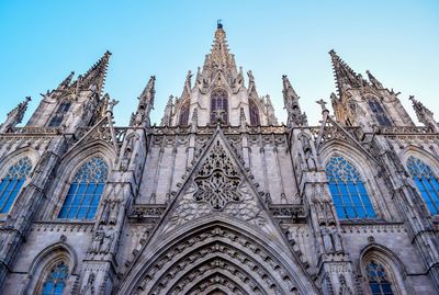 Low angle view of barcelona cathedral against clear sky in city