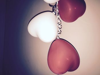 Close-up of balloons hanging over white background