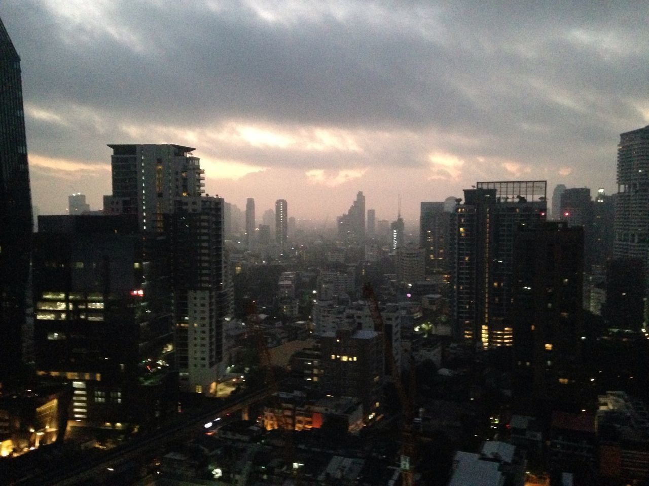 ILLUMINATED MODERN BUILDINGS IN CITY AGAINST SKY