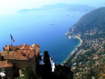 High angle view of cityscape by sea against sky