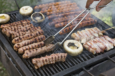 Preparing barbecue meat at picnic in nature. the meat is roasted in a conventional way.