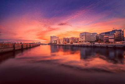 View of city at waterfront during sunset