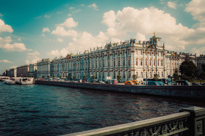 Boats in river with city in background
