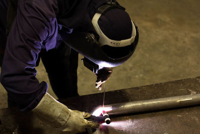 Man working on metal structure in factory