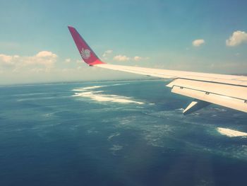 Cropped image of airplane over sea