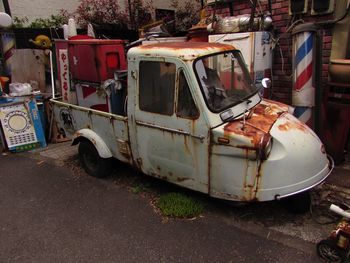 Abandoned car on street in city