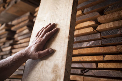 High angle view of human hand on wood