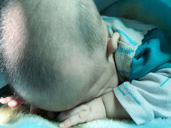 Close-up of baby sleeping on bed