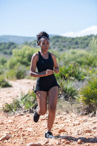 Full length of young woman running