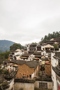 High angle view of buildings in town against sky