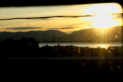 Scenic view of lake at sunset