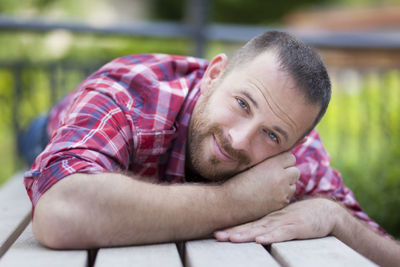 Portrait of smiling man on wooden table