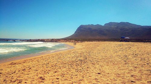 Scenic view of beach against clear sky