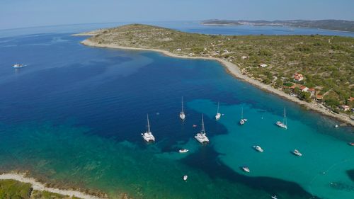 Beautiful bay with sailing boat. vacations, travel and active lifestyle concept