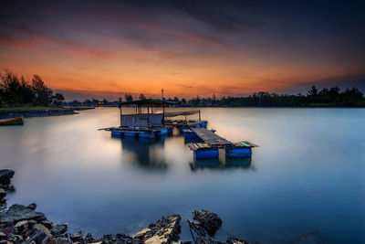 Scenic view of lake against sky during sunset