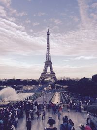 People standing against eiffel tower and sky in city
