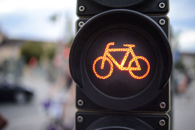 Close-up of bicycle sign against blurred background