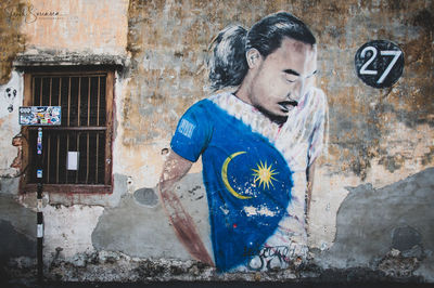 Man standing against graffiti wall