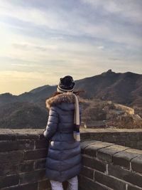 Rear view of woman standing by fortified wall at great wall of china