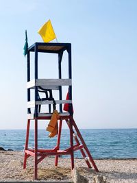 Lifeguard hut on beach against clear sky