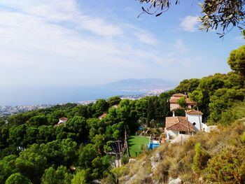 High angle view of townscape by sea against sky