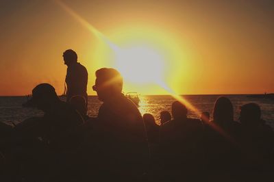 People on beach at sunset