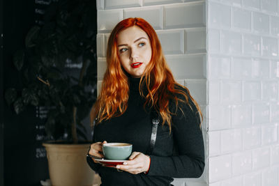 Young woman drinking coffee cup