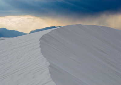 Scenic view of mountains against cloudy sky