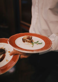 High angle view of person holding drink served on table