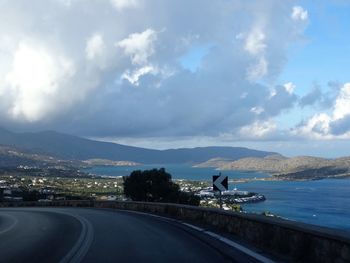 Road by sea against sky in city