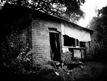 Abandoned house with trees in background