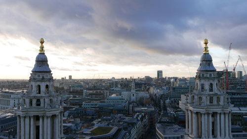 View of buildings in city at sunset