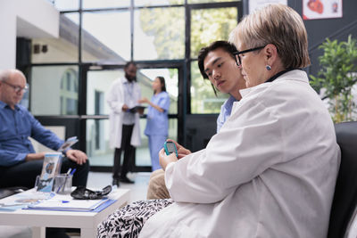 Female doctor examining patient in office