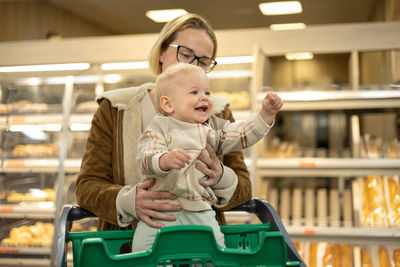 Portrait of smiling young woman standing in store