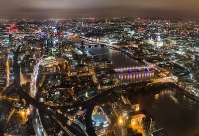 High angle view of city lit up at night