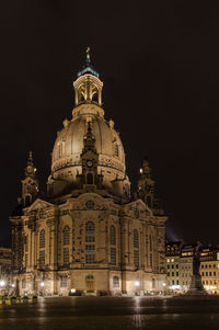 Illuminated building against sky at night