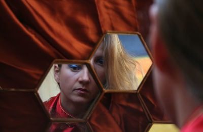 Reflection of thoughtful woman in mirror