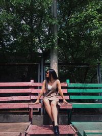 Full length of woman sitting on bench