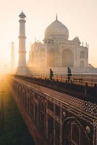 Tourist visiting taj mahal during sunrise