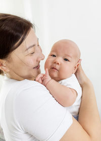 Baby and mother at home. maternal hugs. motherhood,family. asian representation