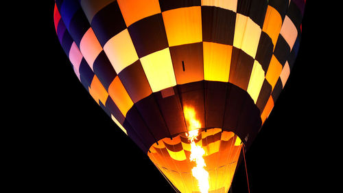 Low angle view of hot air balloon against black background