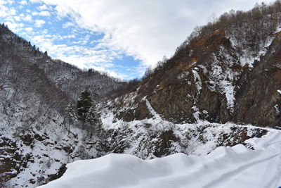 Scenic view of snow covered mountains against sky