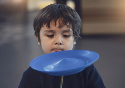 Close-up of boy playing with toy