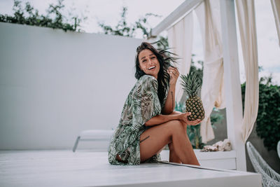 Portrait of young woman sitting outdoors