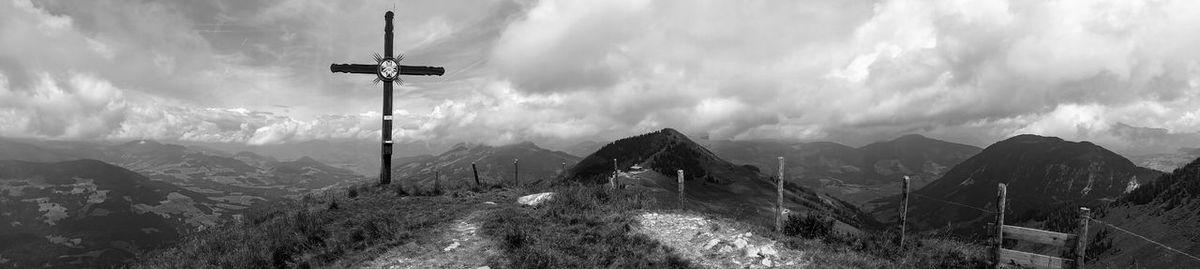 Panoramic view of overhead cable car against sky