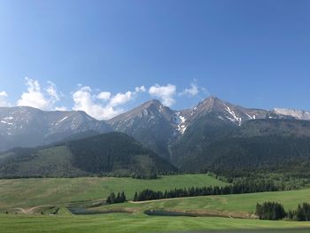 Scenic view of mountains against blue sky