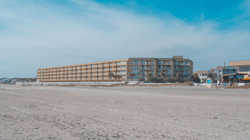 View of building under construction against blue sky