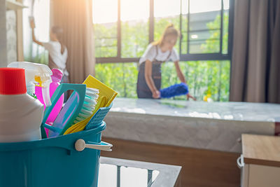 Woman standing by window at home